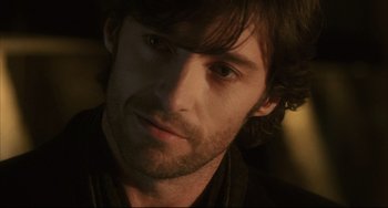Movie still from “The Fountain” (2006), directed by Darren Aronofsky – A man's face in a dark room; Close Up shot, Over the shoulder angle