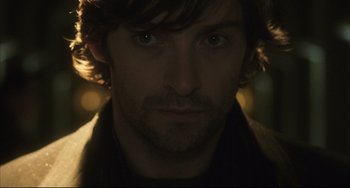Movie still from “The Fountain” (2006), directed by Darren Aronofsky – A man's face in the dark; Close Up shot, Over the shoulder angle