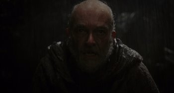 Movie still from “The Fountain” (2006), directed by Darren Aronofsky – A man with a beard and a wet jacket; Close Up shot, Over the shoulder angle