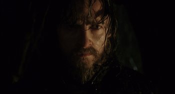 Movie still from “The Fountain” (2006), directed by Darren Aronofsky – A person with wet hair and a beard; Close Up shot, Low angle