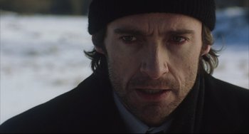 Movie still from “The Fountain” (2006), directed by Darren Aronofsky – A person wearing a hat and a jacket; Close Up shot, Over the shoulder angle