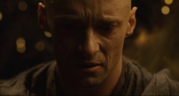 Movie still from “The Fountain” (2006), directed by Darren Aronofsky – A man with a bald head is looking down; Close Up shot, Low angle