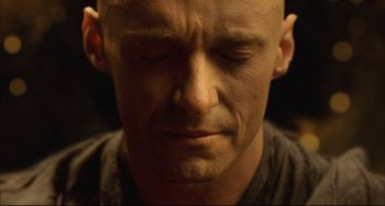 Movie still from “The Fountain” (2006), directed by Darren Aronofsky – A bald man with his eyes closed and his head tilted to the side; Close Up shot, High angle