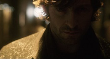 Movie still from “The Fountain” (2006), directed by Darren Aronofsky – A man's face in the dark; Close Up shot, Over the shoulder angle