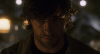 Movie still from “The Fountain” (2006), directed by Darren Aronofsky – A man's face in the dark; Close Up shot, Over the shoulder angle