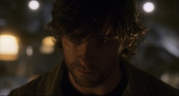 Movie still from “The Fountain” (2006), directed by Darren Aronofsky – Close up of a man's face in the dark; Close Up shot, Over the shoulder angle