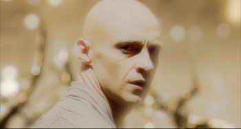 Movie still from “The Fountain” (2006), directed by Darren Aronofsky – A man with bald head looking into the distance; Close Up shot, Low angle