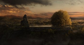 Movie still from “The Fountain” (2006), directed by Darren Aronofsky – An image of an image of a sunset in the background; Extreme Wide shot, Low angle