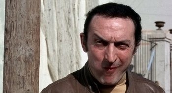 Movie still from “The French Connection” (1971), directed by William Friedkin – A person wearing a brown jacket; Close Up shot, Low angle