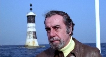 Movie still from “The French Connection” (1971), directed by William Friedkin – An older man standing in front of a lighthouse; Close Up shot, Low angle