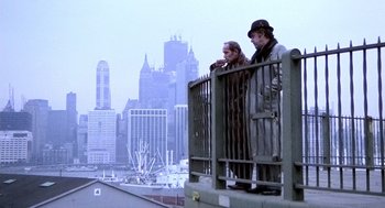 Movie still from “The French Connection” (1971), directed by William Friedkin – Two men standing on a bridge looking at a city; Wide shot, Low angle
