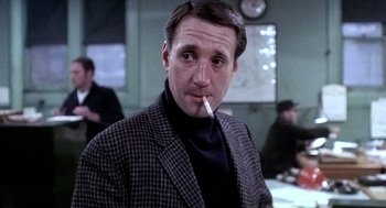 Movie still from “The French Connection” (1971), directed by William Friedkin – A man with a cigarette in his mouth; Close Up shot, Low angle