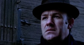 Movie still from “The French Connection” (1971), directed by William Friedkin – A person wearing a hat; Close Up shot, Low angle