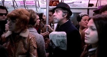 Movie still from “The French Connection” (1971), directed by William Friedkin – A group of people standing around a subway train; Medium shot, Over the shoulder angle