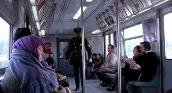 Movie still from “The French Connection” (1971), directed by William Friedkin – A man in a uniform standing on a subway train; Wide shot, Over the shoulder angle