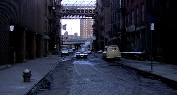 Movie still from “The French Connection” (1971), directed by William Friedkin – A street scene with cars parked on the side of the road; Extreme Wide shot, High angle