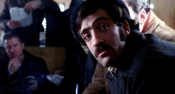 Movie still from “The French Connection” (1971), directed by William Friedkin – A person wearing a hat; Close Up shot, Low angle