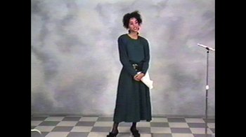 Movie still from “The Fresh Prince of Bel-Air Reunion” (2020), directed by Marcus Raboy – A woman standing in front of a wall holding papers; Medium shot, Overhead angle