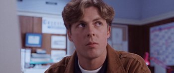 Movie still from “The Frighteners” (1996), directed by Peter Jackson – A person wearing a brown jacket; Close Up shot, Low angle