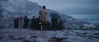 Movie still from “The Frighteners” (1996), directed by Peter Jackson – A group of people standing on top of a snow covered slope; Extreme Wide shot, High angle