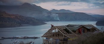 Movie still from “The Frighteners” (1996), directed by Peter Jackson – A man standing on top of a wooden structure; Extreme Wide shot, Low angle