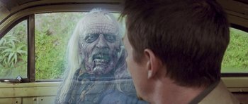 Movie still from “The Frighteners” (1996), directed by Peter Jackson – A man looking into a mirror with a monster face on it; Close Up shot, Over the shoulder angle