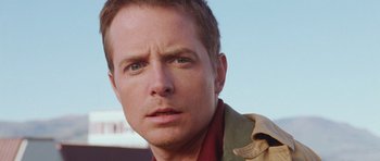 Movie still from “The Frighteners” (1996), directed by Peter Jackson – A man with a serious look on his face; Close Up shot, Low angle