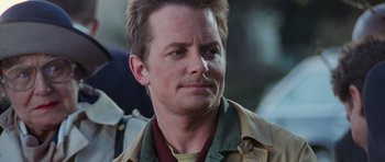 Movie still from “The Frighteners” (1996), directed by Peter Jackson – A person wearing a jacket; Close Up shot, Over the shoulder angle