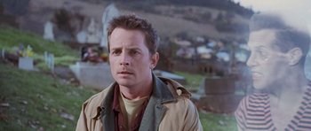 Movie still from “The Frighteners” (1996), directed by Peter Jackson – A person wearing a jacket; Close Up shot, Over the shoulder angle