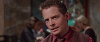 Movie still from “The Frighteners” (1996), directed by Peter Jackson – A person wearing a shirt and a tie; Close Up shot, Over the shoulder angle