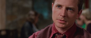 Movie still from “The Frighteners” (1996), directed by Peter Jackson – A person wearing a tie; Close Up shot, Over the shoulder angle