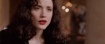 Movie still from “The Frighteners” (1996), directed by Peter Jackson – A person with curly brown hair and red lipstick; Close Up shot, Over the shoulder angle