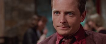 Movie still from “The Frighteners” (1996), directed by Peter Jackson – A person wearing a red shirt; Close Up shot, Over the shoulder angle
