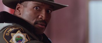 Movie still from “The Frighteners” (1996), directed by Peter Jackson – A person wearing a hat; Close Up shot, Low angle