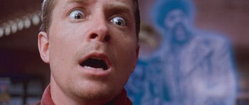 Movie still from “The Frighteners” (1996), directed by Peter Jackson – A man's face as he stares upward at the camera; Close Up shot, Low angle