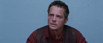 Movie still from “The Frighteners” (1996), directed by Peter Jackson – A person with blood on his face; Close Up shot, High angle