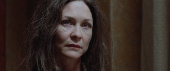 Movie still from “The Frighteners” (1996), directed by Peter Jackson – A person with long brown hair; Close Up shot, Low angle