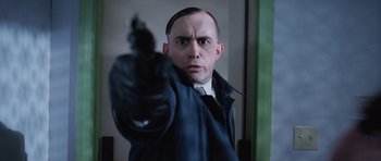 Movie still from “The Frighteners” (1996), directed by Peter Jackson – A man holding a gun up to his face; Close Up shot, Low angle