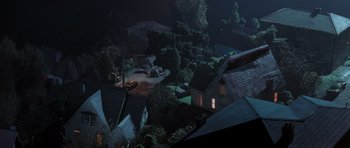 Movie still from “The Frighteners” (1996), directed by Peter Jackson – An aerial view of a night time scene of a town; Extreme Wide shot, High angle