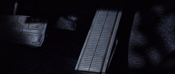 Movie still from “The Frighteners” (1996), directed by Peter Jackson – View of a metal object in the dark; Extreme Close Up shot, Overhead angle