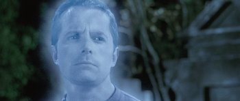 Movie still from “The Frighteners” (1996), directed by Peter Jackson – A person wearing a black shirt; Close Up shot, Over the shoulder angle