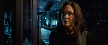 Movie still from “The Frighteners” (1996), directed by Peter Jackson – A person wearing a black shirt; Close Up shot, Over the shoulder angle