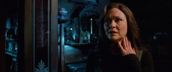 Movie still from “The Frighteners” (1996), directed by Peter Jackson – A woman standing in front of a mirror in a dark room; Close Up shot, Over the shoulder angle