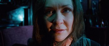 Movie still from “The Frighteners” (1996), directed by Peter Jackson – A woman's face in a dimly - lit room; Close Up shot, Low angle