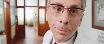 Movie still from “The Frighteners” (1996), directed by Peter Jackson – A person wearing glasses; Close Up shot, Low angle