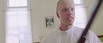 Movie still from “The Frighteners” (1996), directed by Peter Jackson – A man with blonde hair wearing a chef's outfit; Close Up shot, Low angle