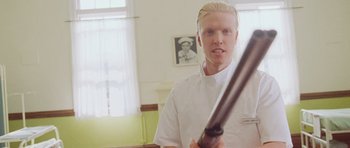 Movie still from “The Frighteners” (1996), directed by Peter Jackson – A man with blonde hair holding a baseball bat in a room; Medium shot, Low angle