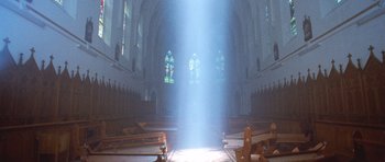 Movie still from “The Frighteners” (1996), directed by Peter Jackson – The sun is shining through the stained - glass windows of a church; Extreme Wide shot, Low angle