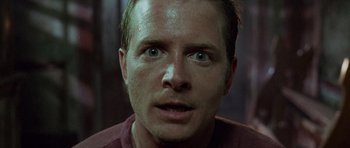 Movie still from “The Frighteners” (1996), directed by Peter Jackson – A person looking at the camera; Close Up shot, Low angle