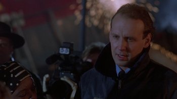 Movie still from “The Fugitive” (1993), directed by Andrew Davis – A person with a camera; Close Up shot, Low angle